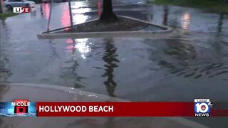 Police officers warn of pooling on the roads in Hollywood Beach