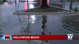Police officers warn of pooling on the roads in Hollywood Beach